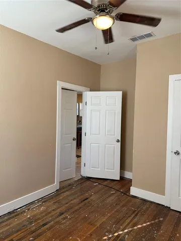 a view of an empty room with a ceiling fan