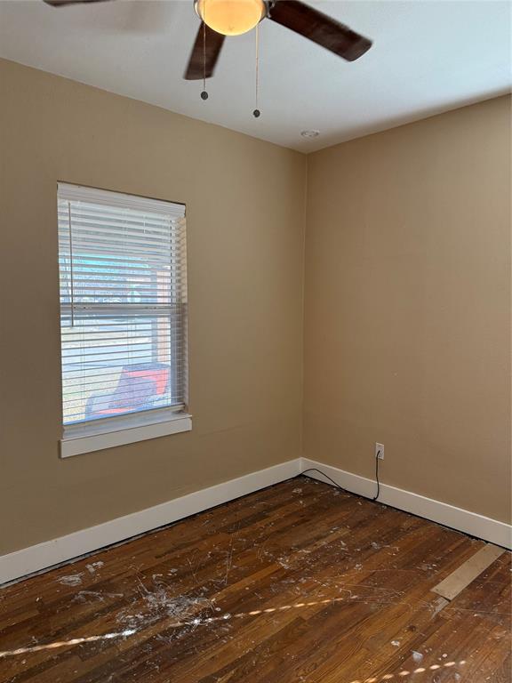 809 South Wine Street Gainesville, TX 76240 - Photo 25 of 33 an empty room with wooden floor and windows