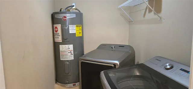 a view of a backyard with large trees and wooden fence