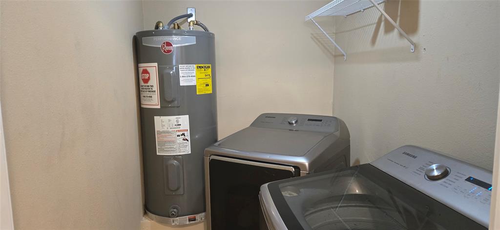 809 South Wine Street Gainesville, TX 76240 - Photo 26 of 33 Laundry area featuring water heater and washing machine and clothes dryer