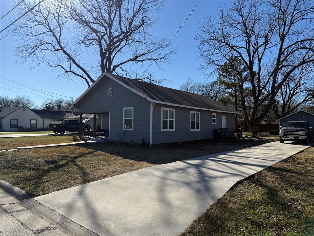 809 South Wine Street Gainesville, TX 76240 - Photo 5 of 33 a front view of a house with a yard covered with snow