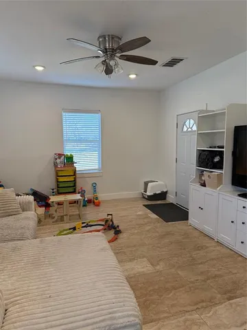 a kitchen with a sink dishwasher and a view of living room