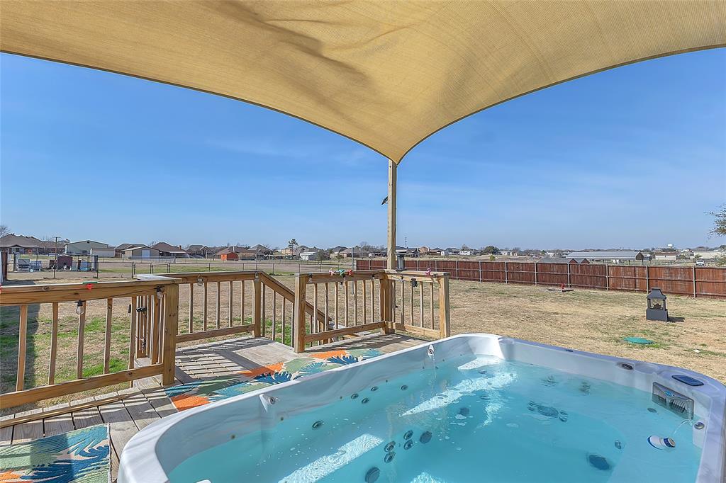 11151 County Road 213 Forney, TX 75126 - Photo 29 of 35 View of swimming pool with a residential view, a hot tub, a fenced backyard, and a wooden deck