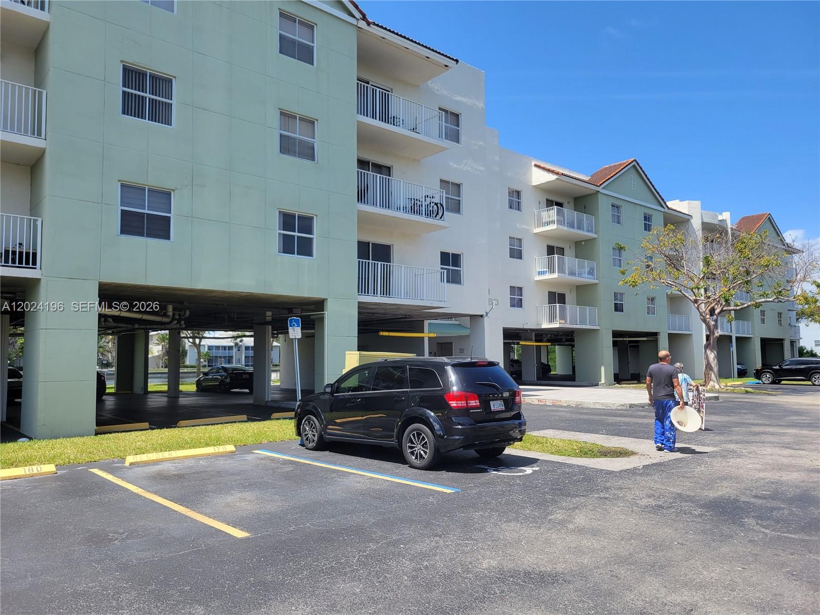 8260 Southwest 210th Street, Unit 319 Cutler Bay, FL 33189 - Photo 19 of 20 a view of a cars park in front of building