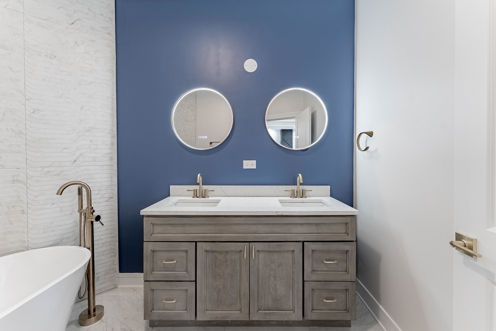 822 North Lockwood Avenue Chicago, IL 60651 - Photo 17 of 63 a bathroom with a double vanity sink and a mirror