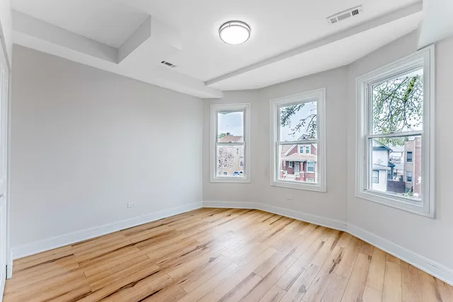 a view of a room with wooden floor closet and windows