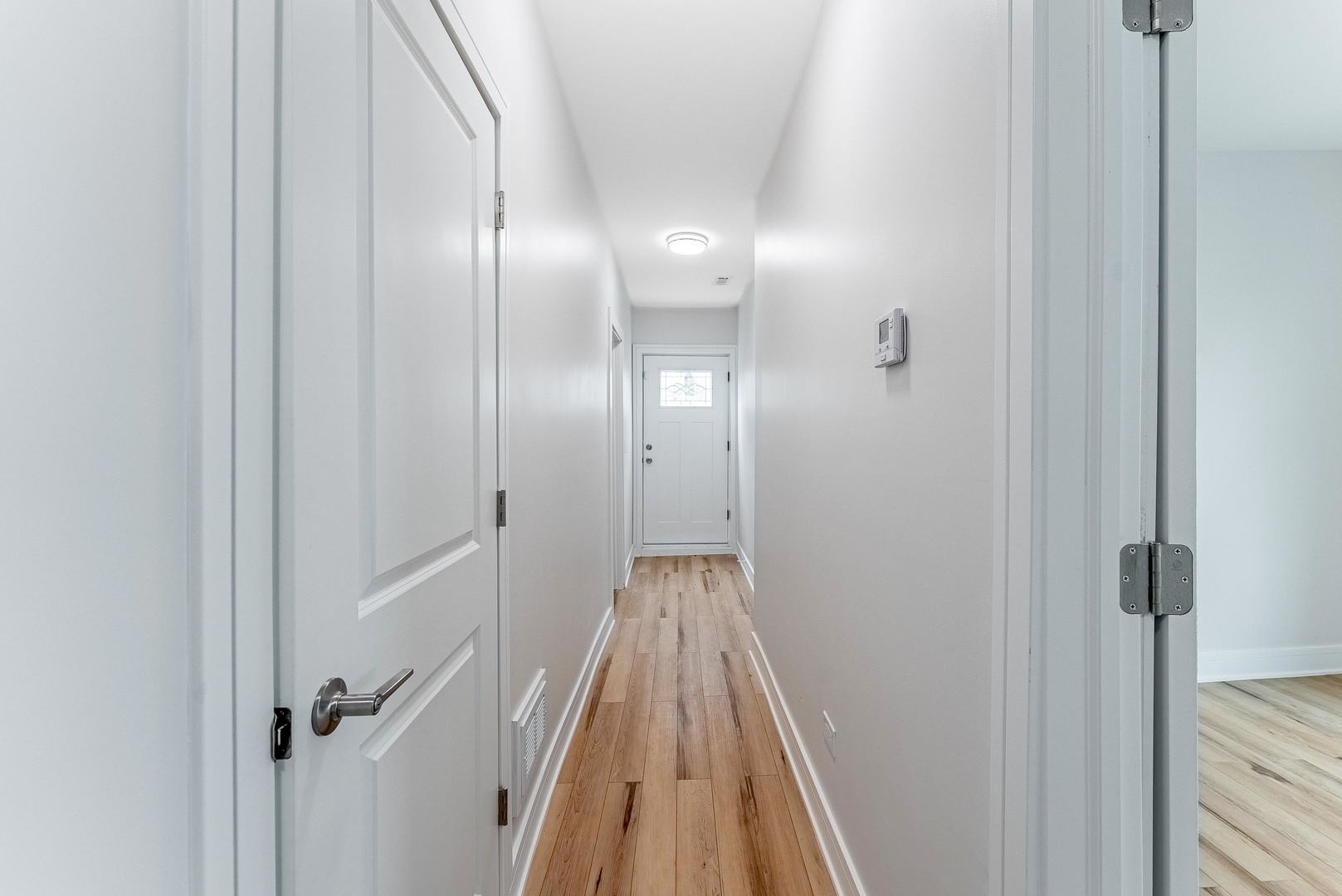 822 North Lockwood Avenue Chicago, IL 60651 - Photo 29 of 63 a view of a hallway with wooden floor and a bathroom