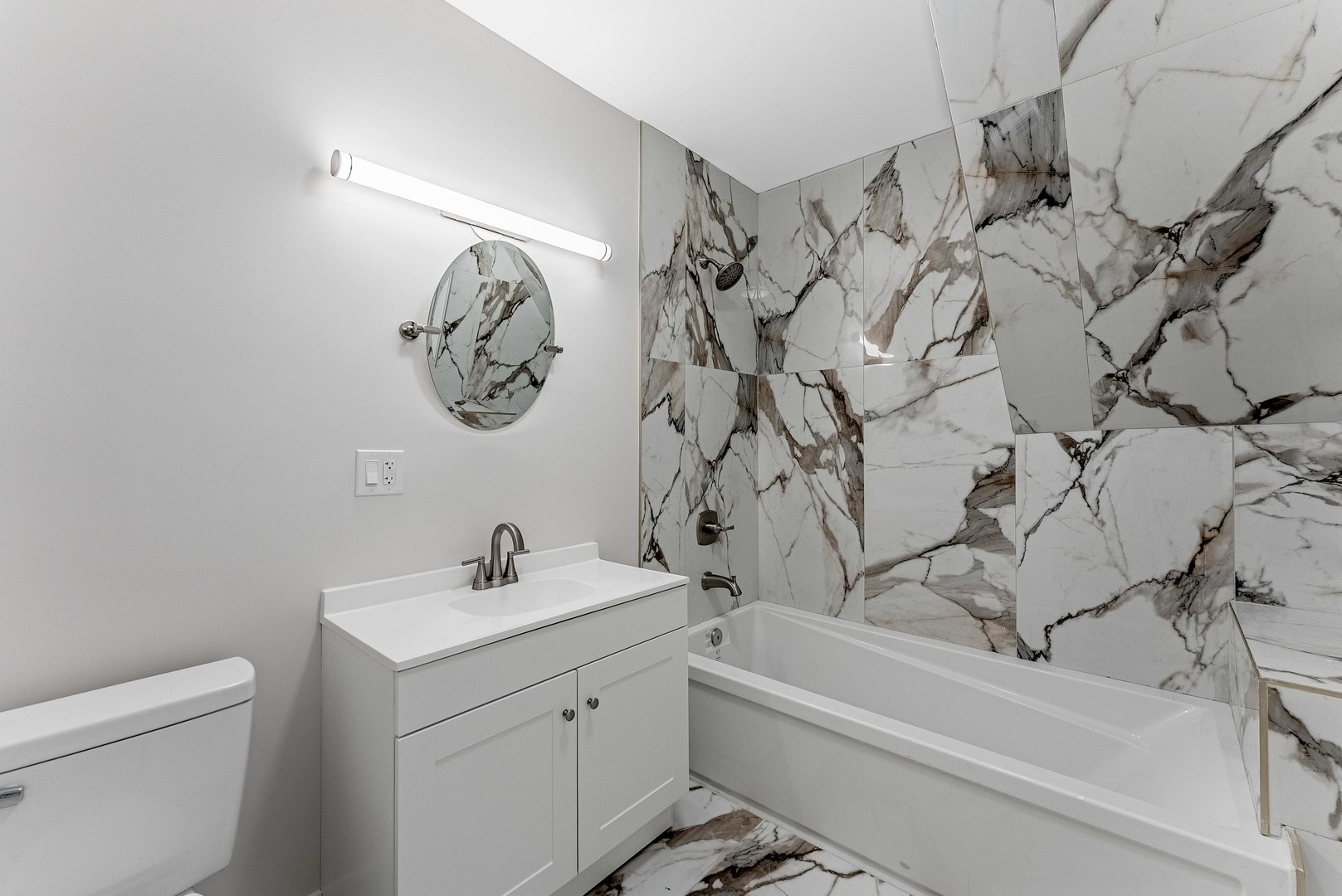 822 North Lockwood Avenue Chicago, IL 60651 - Photo 35 of 63 a bathroom with a sink a toilet and bathtub