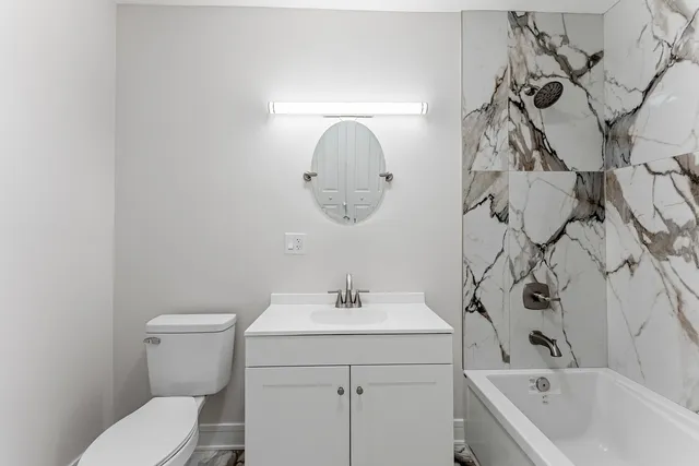 a view of a room with wooden floor and white walls