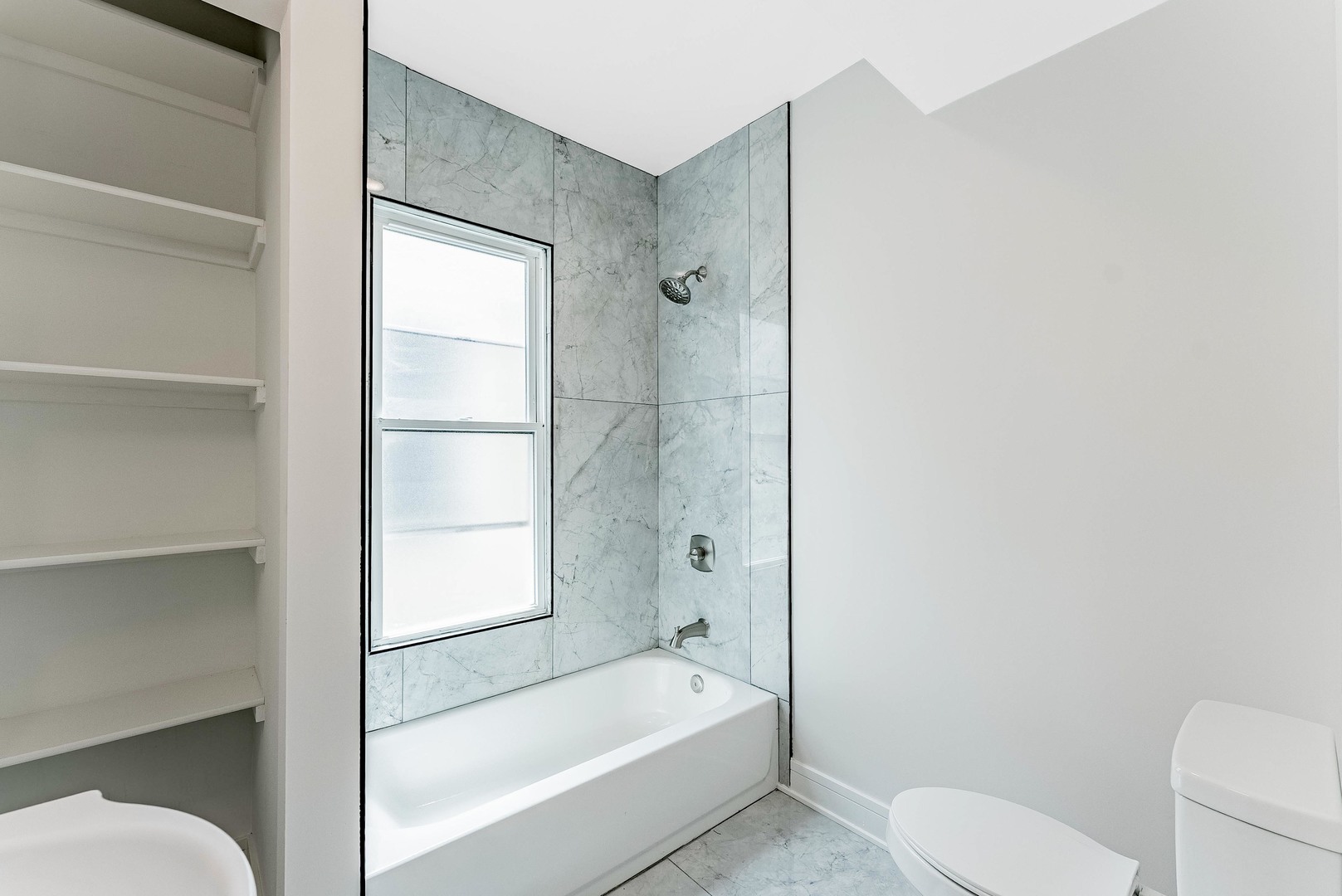 822 North Lockwood Avenue Chicago, IL 60651 - Photo 37 of 63 a bathroom with a toilet and a bathtub