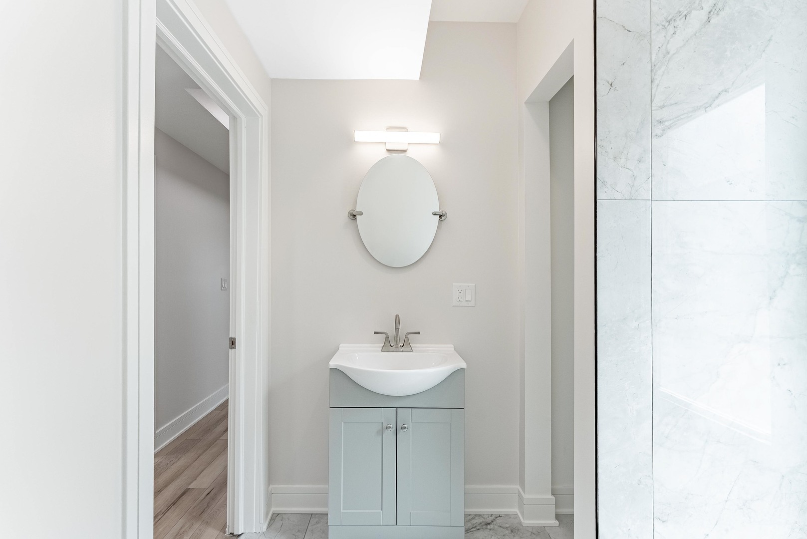 822 North Lockwood Avenue Chicago, IL 60651 - Photo 39 of 63 a bathroom with a sink and a mirror