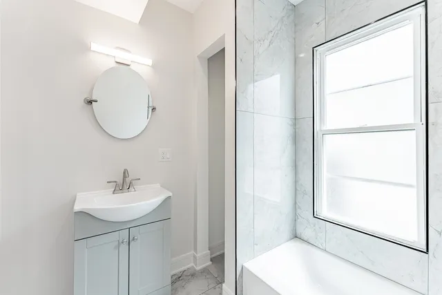 a bathroom with a toilet sink and shower