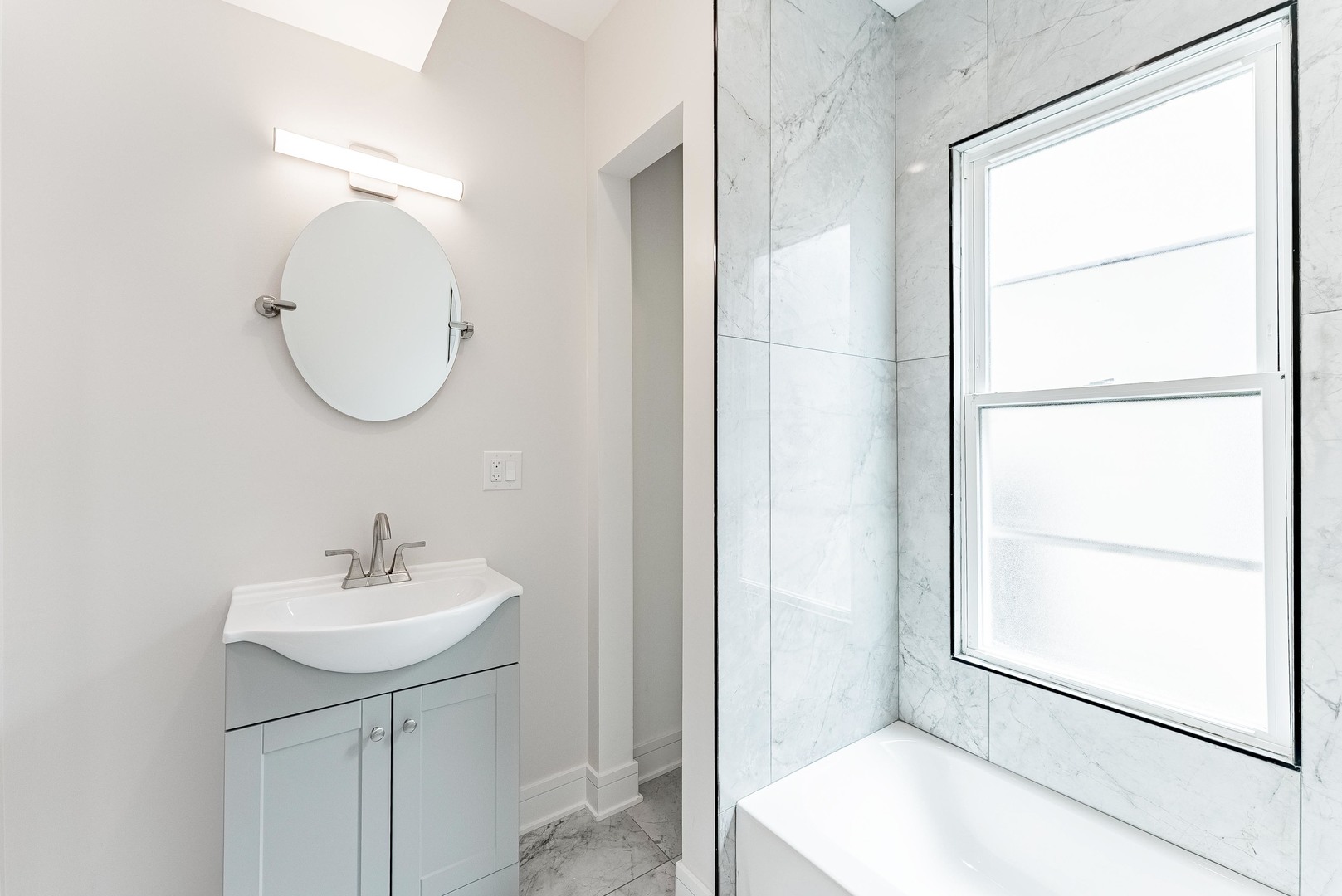 822 North Lockwood Avenue Chicago, IL 60651 - Photo 40 of 63 a bathroom with a sink a shower and a mirror