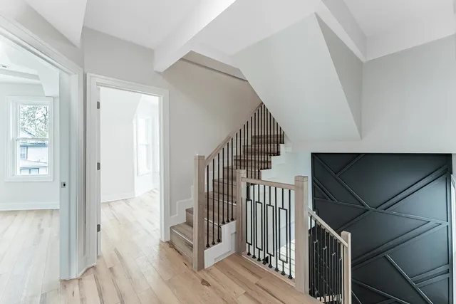 a view of hallway with wooden floor