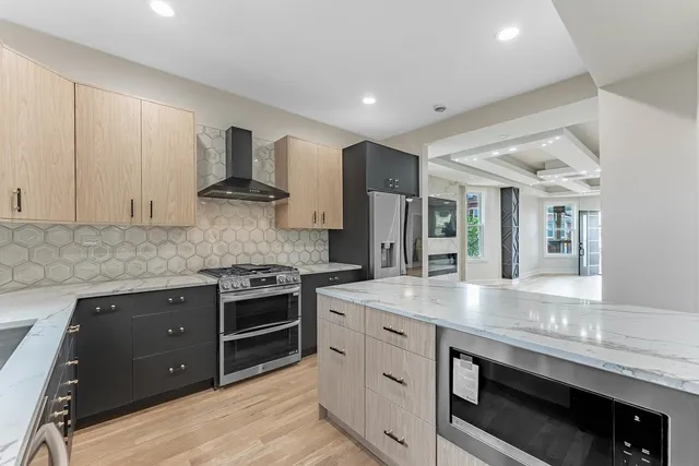 a large kitchen with a sink dishwasher stove and refrigerator