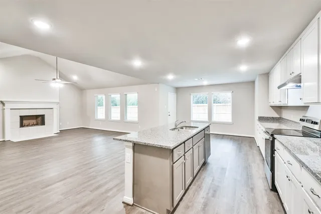 an open kitchen with a sink and dish washer