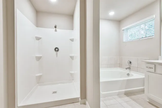 a white bath tub sitting next to a white sink