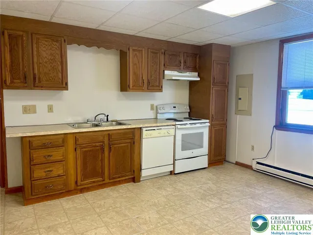a utility room with cabinets washer and dryer