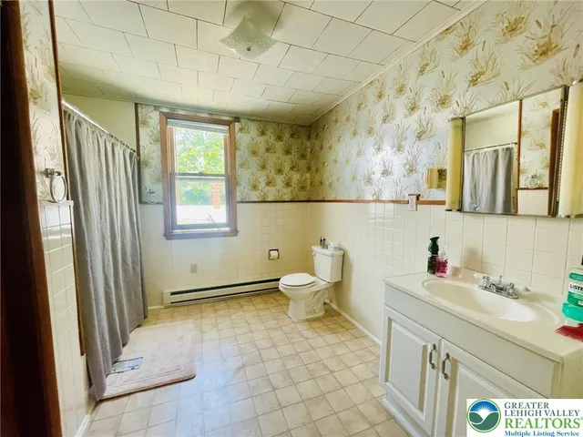 a bathroom with a sink toilet and a mirror