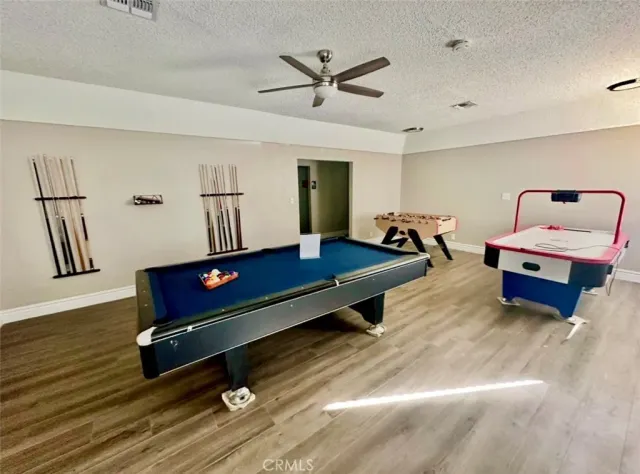 a living room with furniture a table and wooden floor