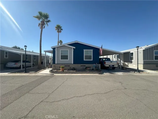 a view of a house with car parked on the road