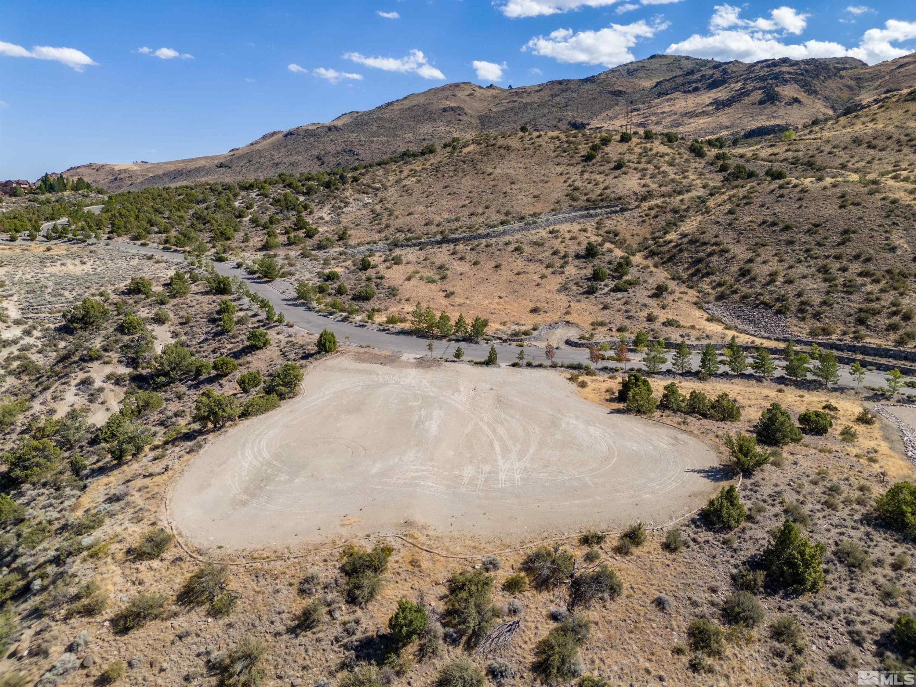 4820 Woodchuck Circle, Unit 2 Reno, NV 89519 - Photo 9 of 11 a view of a dry yard with mountains in the background