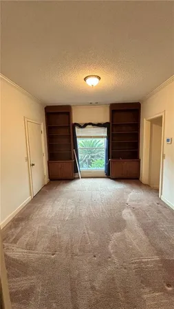 a view of room with an empty space and a window