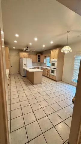 a kitchen with stainless steel appliances a refrigerator and a counter top space