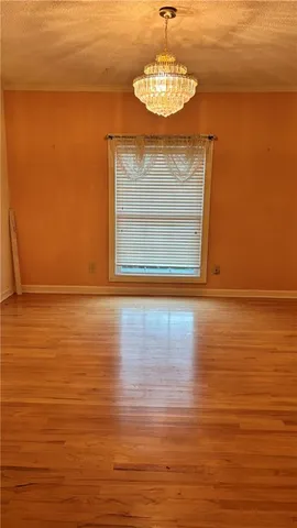 a view of a room with wooden floor and a view of a room