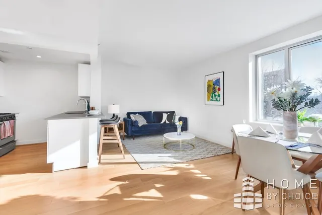 a living room with furniture a potted plant and a table