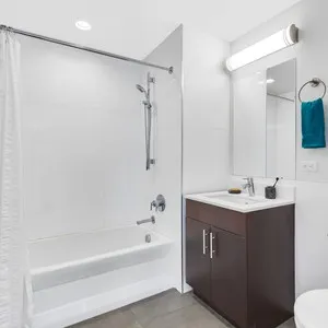 a bathroom with a sink toilet tub and shower