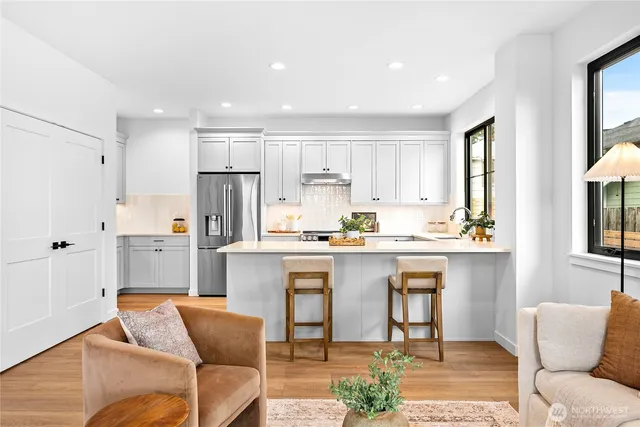 a kitchen with stainless steel appliances granite countertop a refrigerator and microwave