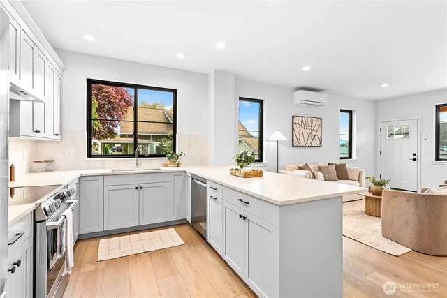a view of a kitchen with a sink stainless steel appliances and windows