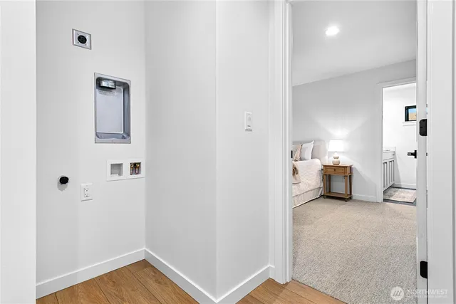 a view of a room with wooden floor and bathroom