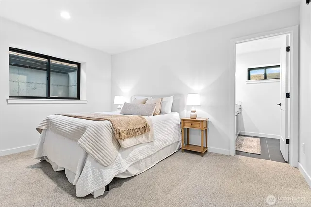 a spacious bedroom with a bed and a painting on the wall