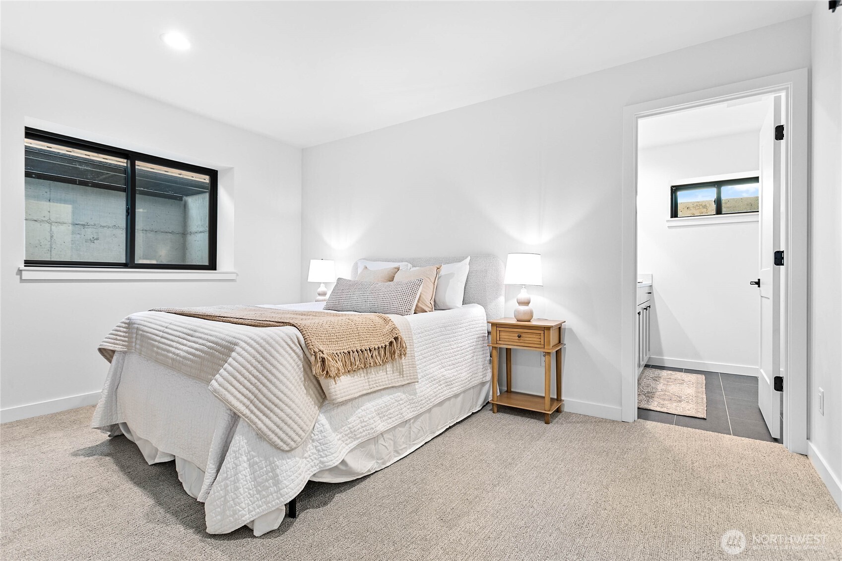 706 Judson Street, Unit A Lynden, WA 98264 - Photo 25 of 35 a spacious bedroom with a bed and a painting on the wall