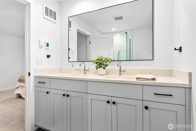 a bathroom with a sink and mirror