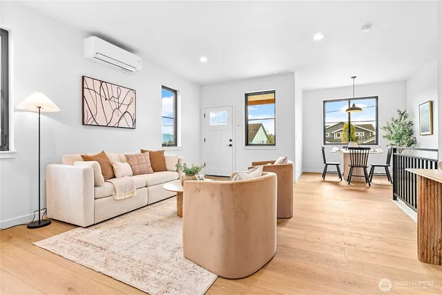 a living room with couches and painting on the wall