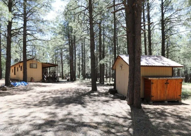 a wooden house with trees in front of it