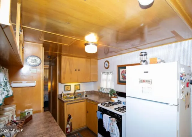 a kitchen with a refrigerator and a stove