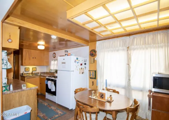 a kitchen with a table and chairs in it