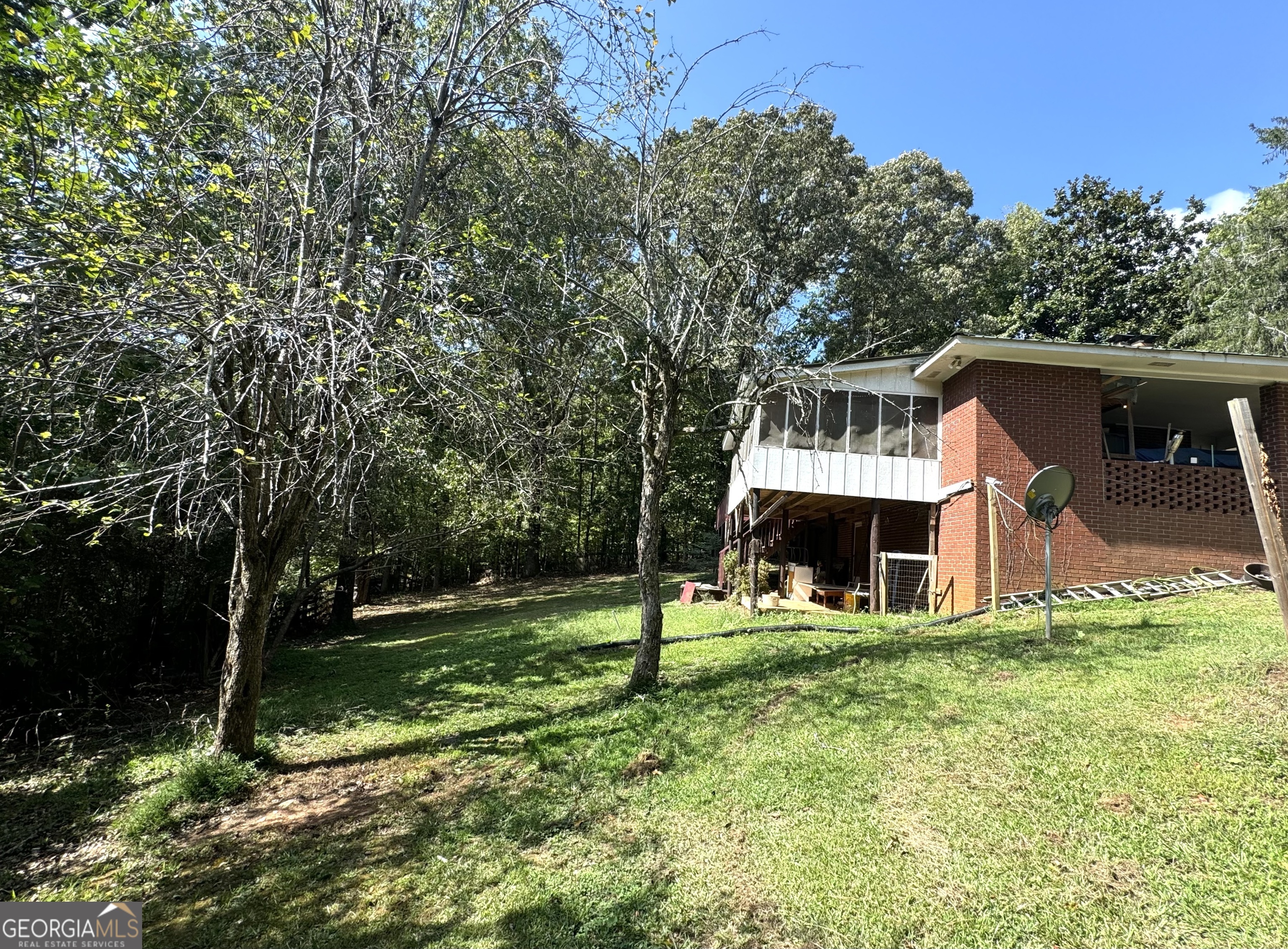 156 Brett Road Cleveland, GA 30528 - Photo 25 of 32 a view of a house with a yard porch and sitting area