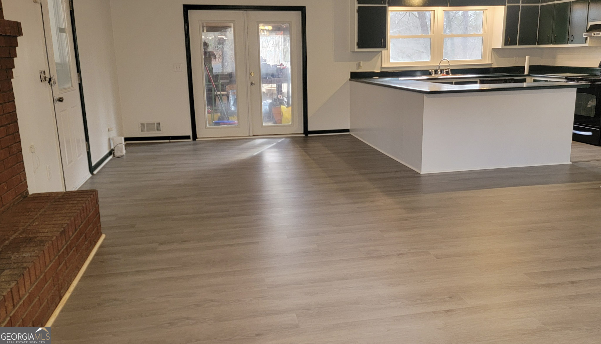 156 Brett Road Cleveland, GA 30528 - Photo 6 of 32 a kitchen with stainless steel appliances granite countertop a sink and a stove