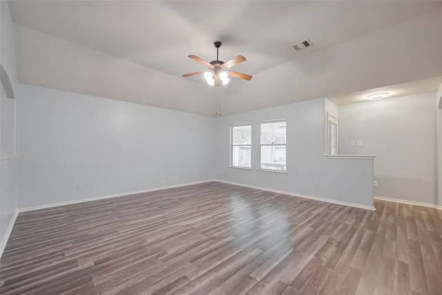 wooden floor in an empty room with a window