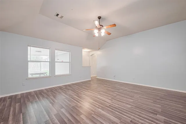 wooden floor in an empty room with a window