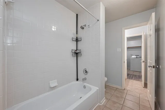 a bathroom with a bathtub and shower