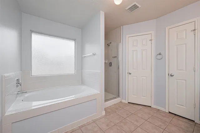 a bathroom with a bathtub and shower