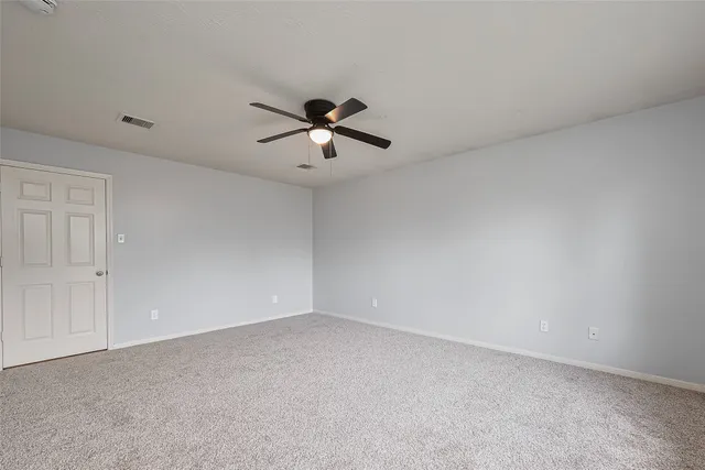 a view of room with a ceiling fan and window