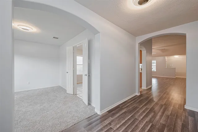 a view of hallway with wooden floor