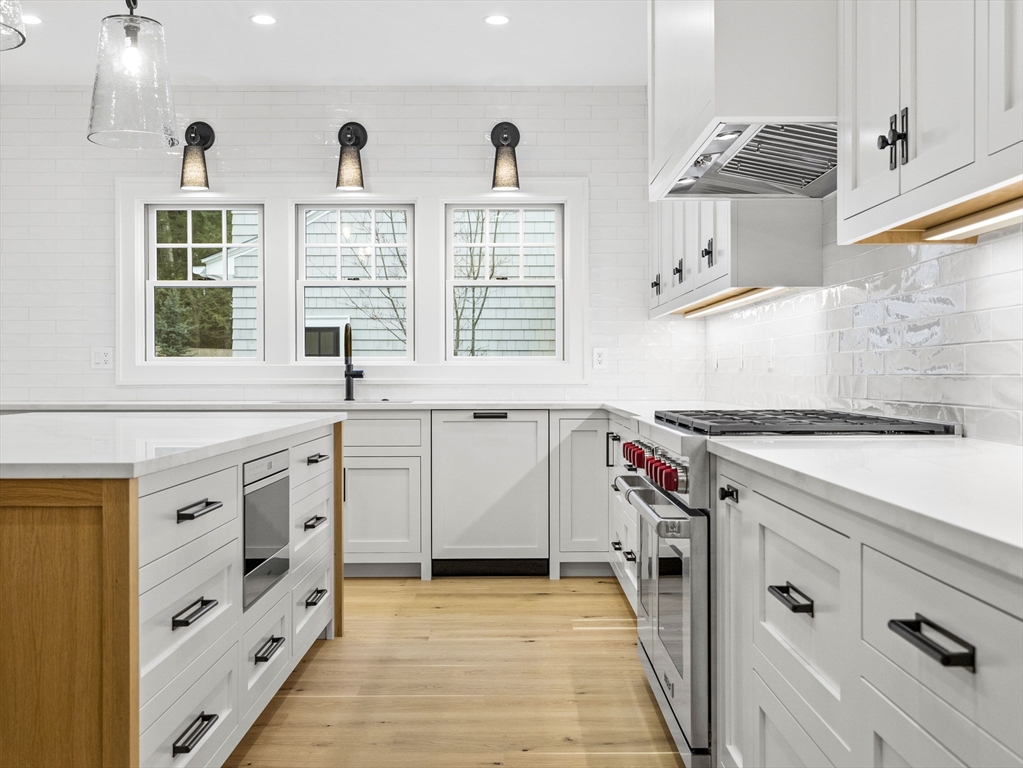 77 Forest Street Wellesley, MA 02481 - Photo 5 of 32 a kitchen with stainless steel appliances a sink and a stove